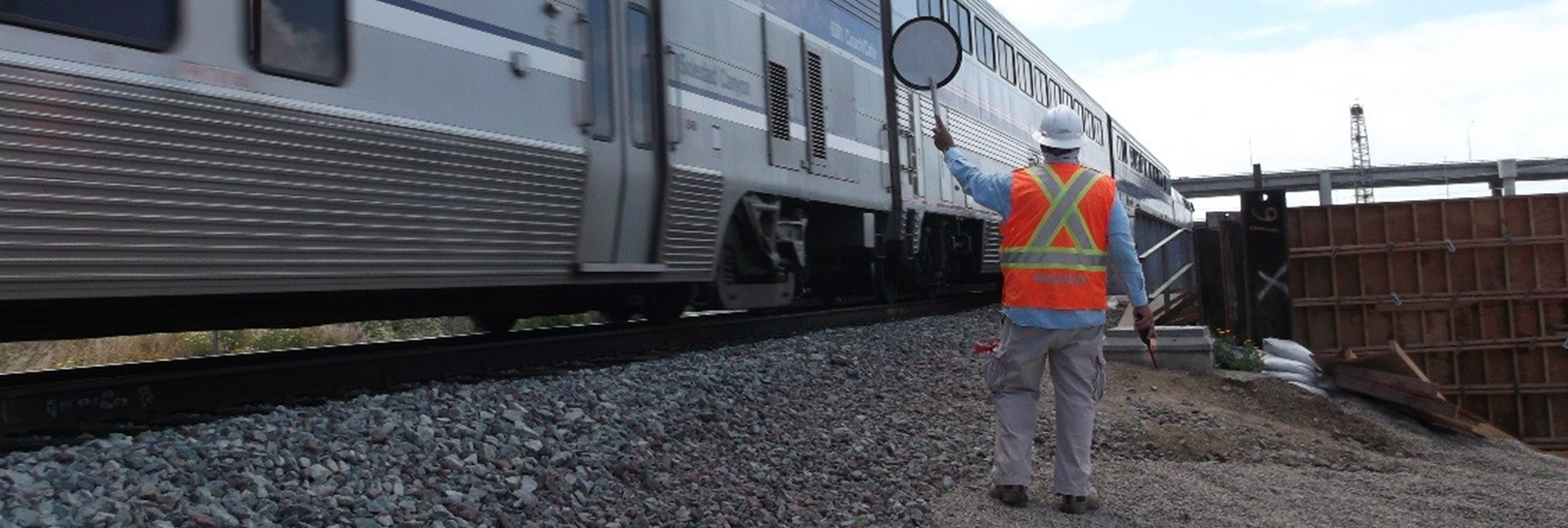 Railroad Flagger directing a train in a rail yard