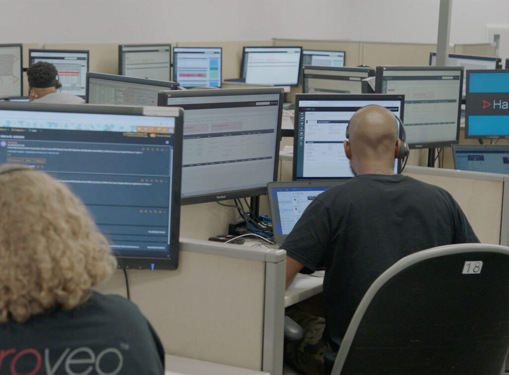 Hallcon dispatchers working behind computer monitors