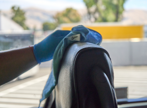 Hallcon employee wiping the interior of a vehicle