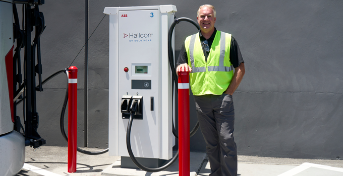 Tom Vollert standing next to an EV charger in Fremont, CA