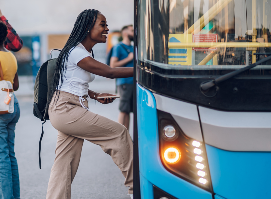 University student smiling and getting on bus