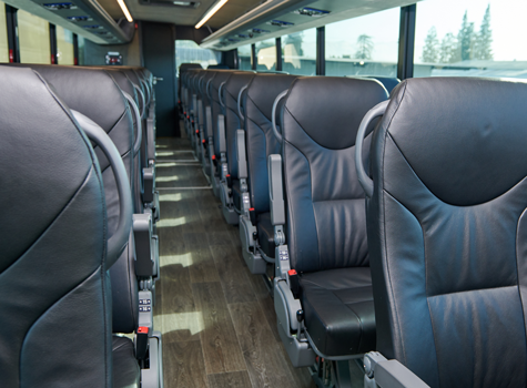 Interior of a clean motorcoach showing rows of seats