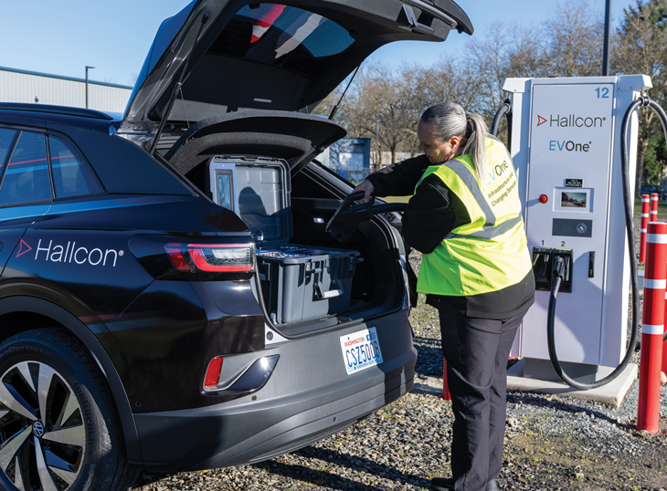 Hallcon employee working on an EV charger