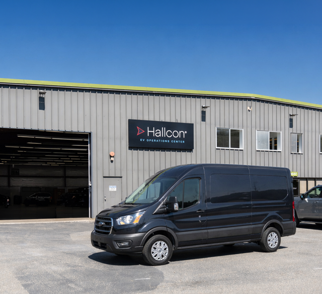 Electric transit van in front of Hallcon EVOne Operations Center in Redmond, WA.