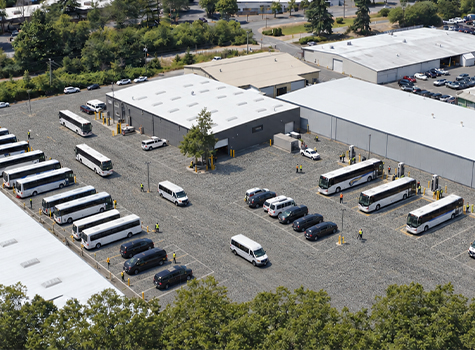 Aerial shot of Hallcon's Redmond facility, with buses parked and charging.